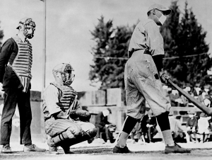John “Beans” Reardon, left, wearing a flu mask underneath his umpire’s mask, prepares to call a pitch in a California Winter League game on January 26, 1919, in Pasadena, California. During a global influenza pandemic, all players and fans were required by city ordinance to wear facial coverings at all times while outdoors. The catcher and batter’s identities are unconfirmed, but the best available evidence suggests it might be Truck Hannah behind the plate and Rube Ellis at bat.