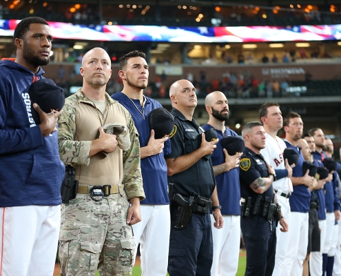 Houston Astros players stand with first responders in the team's first game since Hurricane Harvey on September 2, 2017, at Minute Maid Park in Houston. (COURTESY OF THE HOUSTON ASTROS)