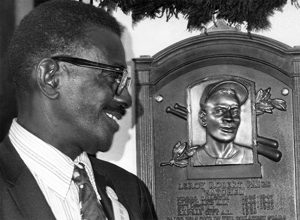 Satchel Paige looks at his plaque during Hall of Fame induction weekend on August 9, 1971, in Cooperstown, New York (NATIONAL BASEBALL HALL OF FAME LIBRARY)
