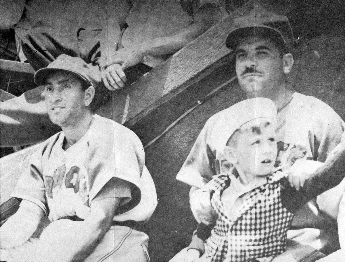 Mexican League president Jorge Pasquel, right, sits with the son of catcher Mickey Owen on his lap and outfielder Danny Gardella, left, during a 1946 game in Veracruz, Mexico. (SABR/Rucker Archive)