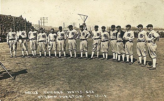 The Chicago White Sox are pictured on April 12, 1918, before an exhibition game against a US Army team at Camp Funston, outside of Junction City, Kansas. Just weeks ear- lier, the first major outbreak of a global influenza pandemic killed 38 soldiers at the base. An estimated 50 million people around the world died from the flu by the time the pandemic subsided in 1920. (BlackBetsy.com)