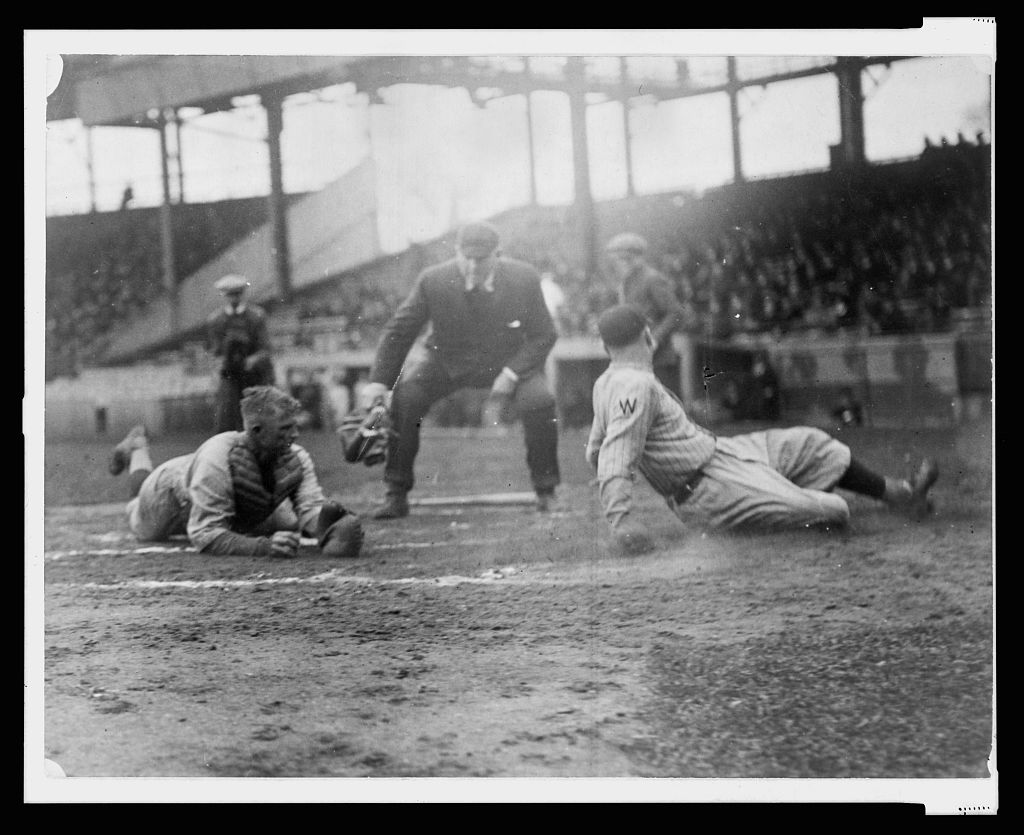 Waiting for the umpire to make the call as Washington ball player, Joe Judge, slides across home plate, the catcher, on the left, is lying on the ground with ball in hand (LIBRARY OF CONGRESS)