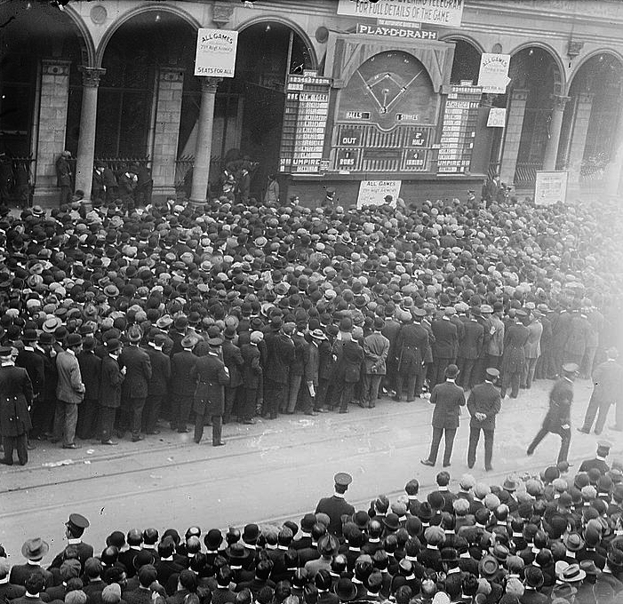 A crowd gathers outside the New York Herald newspaper building to watch a billboard diagram of a game during the 1911 World Series between the Philadelphia A's and New York Giants. (LIBRARY OF CONGRESS)