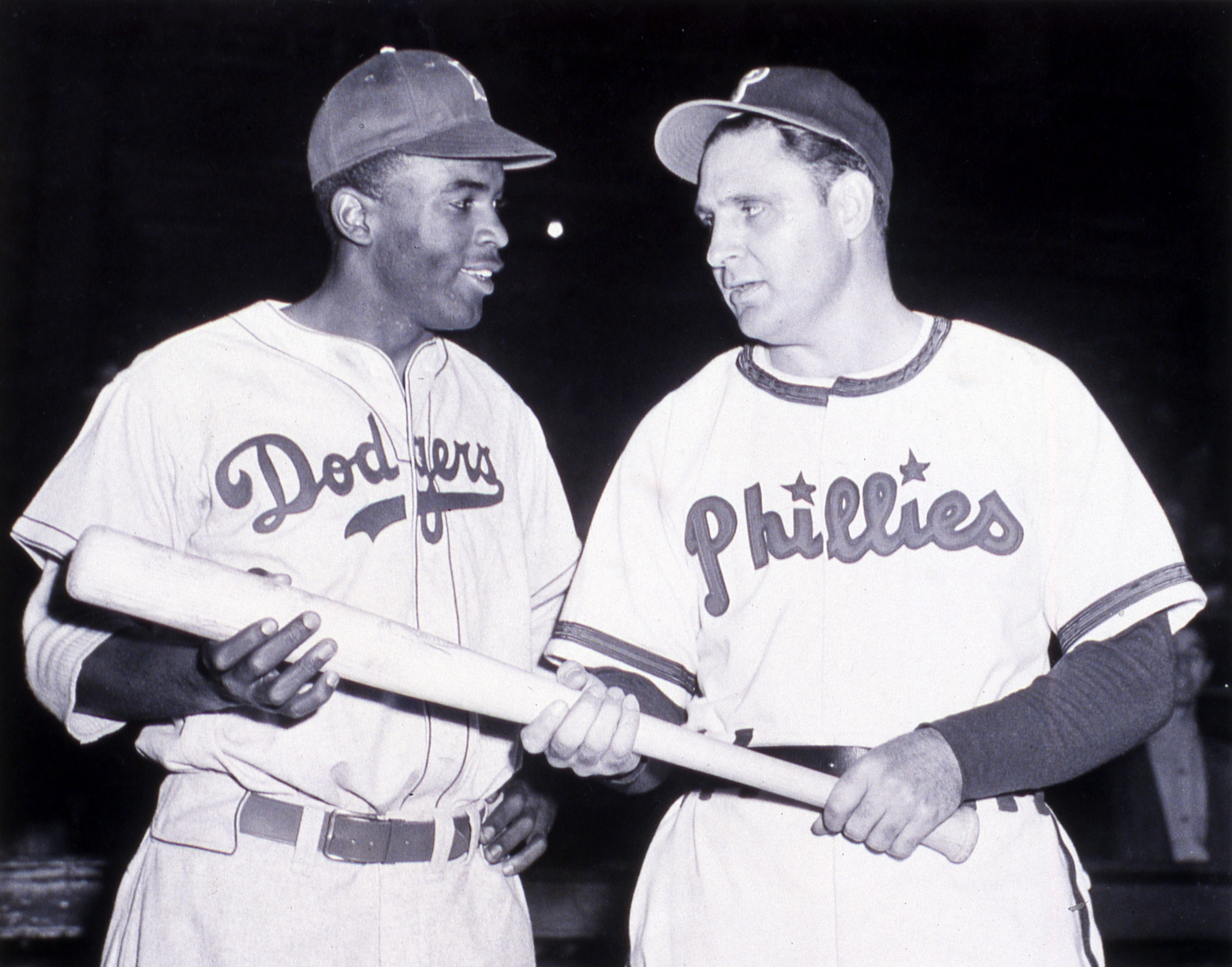 Jackie Robinson of the Brooklyn Dodgers, left, poses for a photo with Philadelphia Phillies manager Ben Chapman, who had instructed his players to unleash a torrent of racist verbal abuse against the Dodgers' rookie when the teams first met on April 22, 1947. (SABR-RUCKER ARCHIVE)