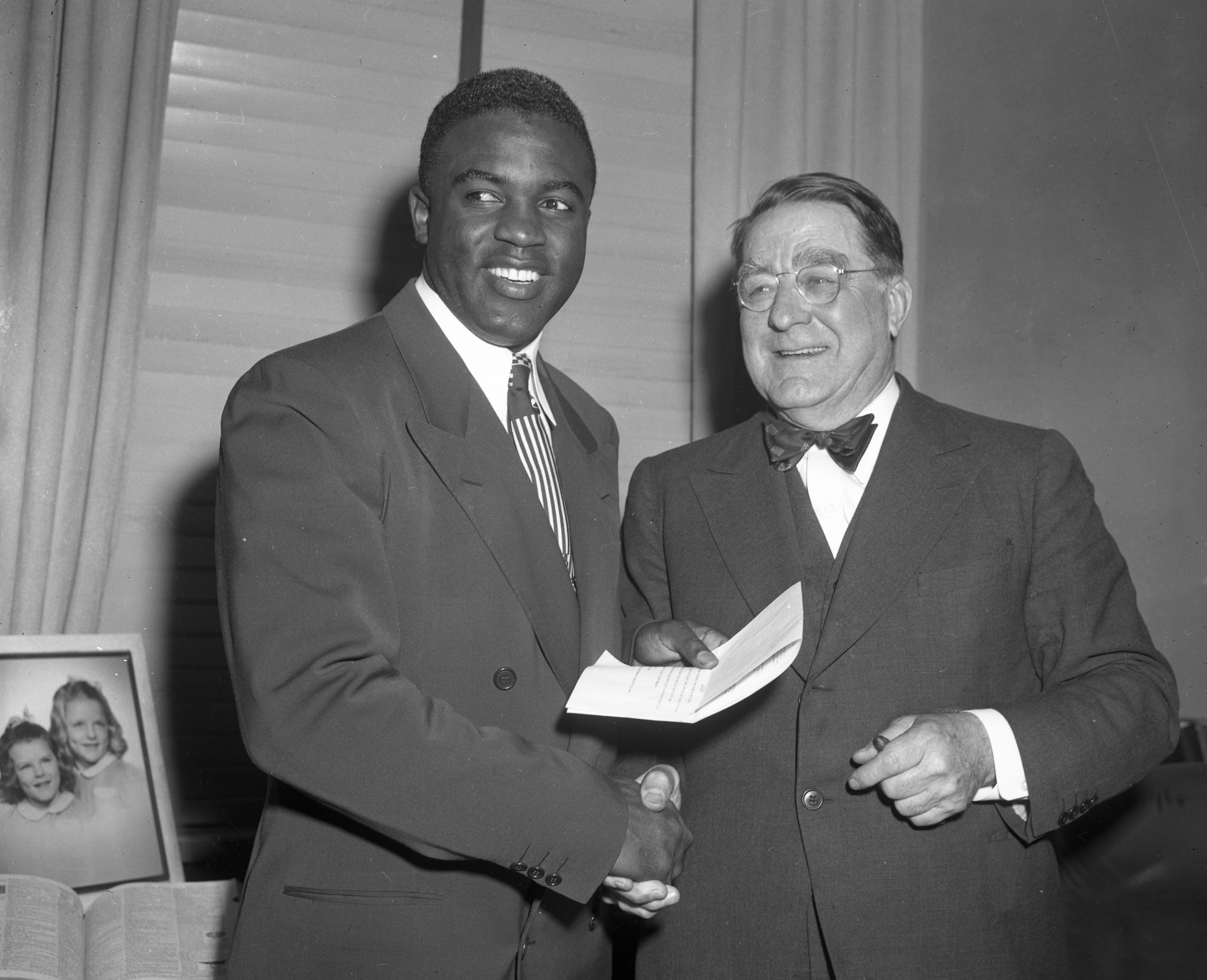 Jackie Robinson and Branch Rickey talk happily after a contract signing meeting in the offices of the Brooklyn Dodgers in Ebbets Field on January 25, 1950. (SABR-RUCKER ARCHIVE) 