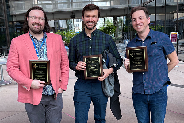 Michael Baumann, Ben Clemens, and Mike Petriello hold their 2023 SABR Analytics Conference Research Award plaques on March 11, 2023, in Phoenix, Arizona. Not pictured is award winner Russell A. Carleton. (Photo: Meg Rowley)