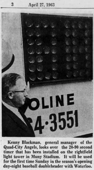 Clipping of a newspaper article from April 27, 1963, showing Kenny Blackman, general manager of the Quad City Angels, looking over an electronic pitch timer installed on the right field light tower in Muny Stadium in Davenport, Iowa. 