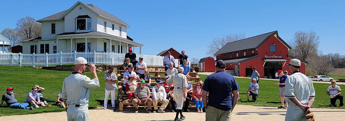 Attendees of the 2024 SABR Dubuque Baseball Classic listen to a "Ghost Players" presentation at the Field of Dreams Movie Site on April 14, 2024, in Dyersville, Iowa.