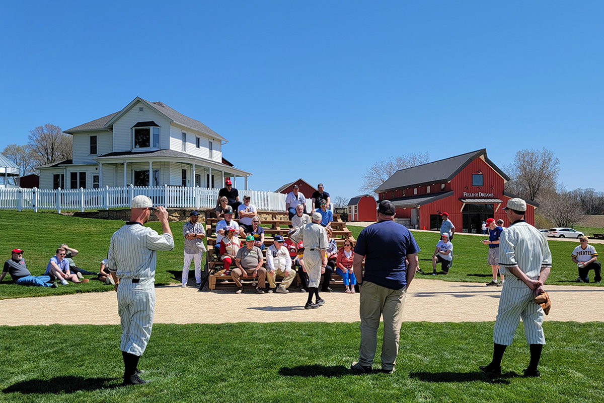 Attendees of the 2024 SABR Dubuque Baseball Classic listen to a "Ghost Players" presentation at the Field of Dreams Movie Site on April 14, 2024, in Dyersville, Iowa.