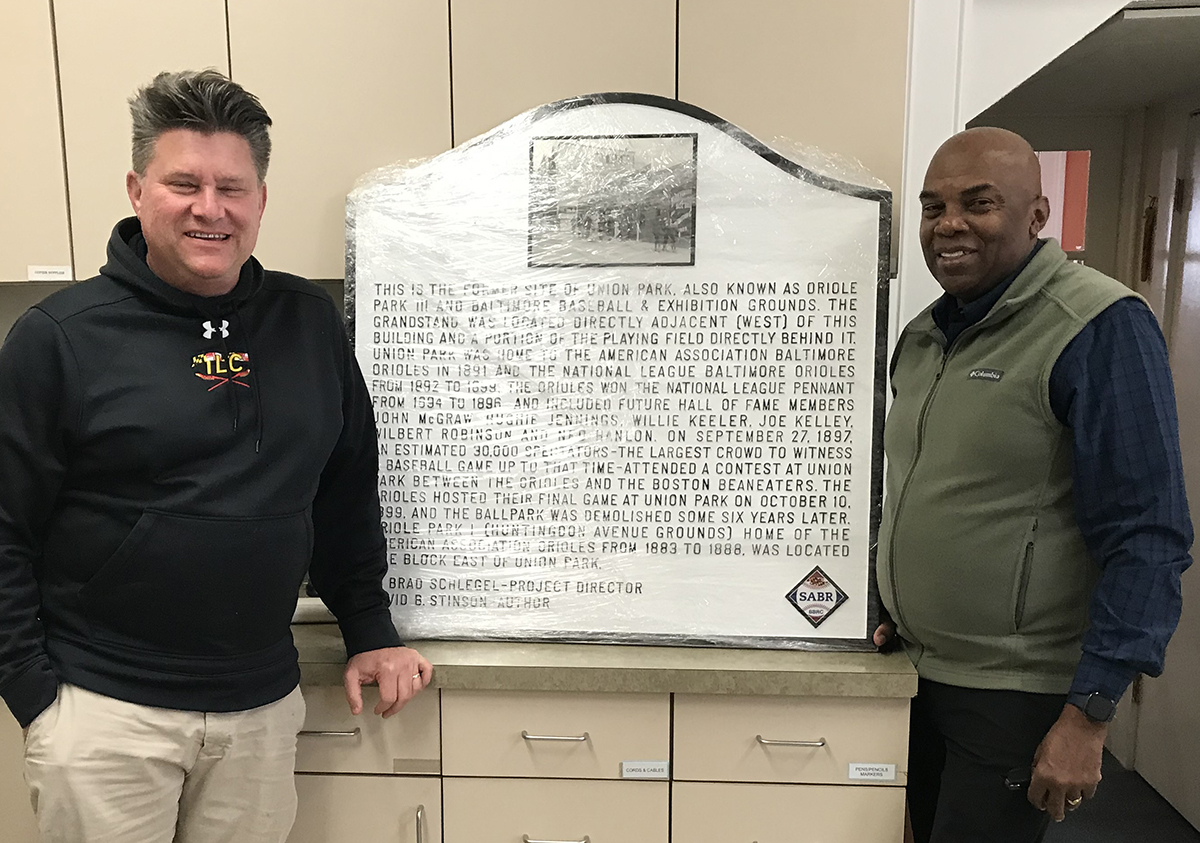 David Sann, left, Director of Real Estate Development, and Gerard Joab, Executive Director of the St. Ambrose Housing Aid Center in Baltimore, stand next to a new historical marker for Union Park, former home of the National League's Baltimore Orioles. (Courtesy of David Stinson)