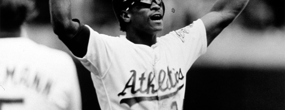 Rickey Henderson holds up a base after he broke Lou Brock's all-time career record for stolen bases on May 1, 1991 (SABR-Rucker Archive)