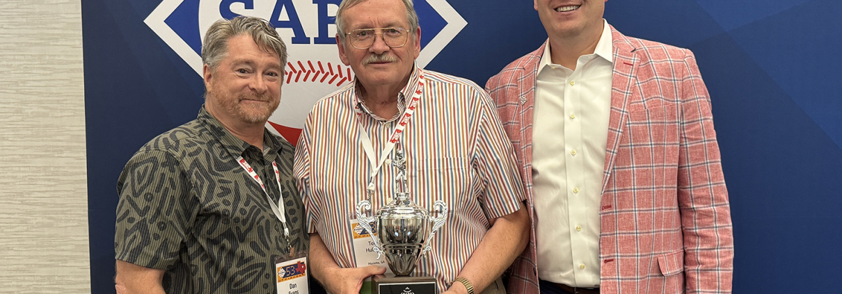 Tom Hufford, SABR's last living founding member, was honored with the 2025 Bob Davids Award. He is flanked by SABR Board President Dan Evans, left, and CEO Scott Bush, right.