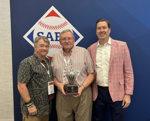Tom Hufford, SABR's last living founding member, was honored with the 2025 Bob Davids Award. He is flanked by SABR Board President Dan Evans, left, and CEO Scott Bush, right.