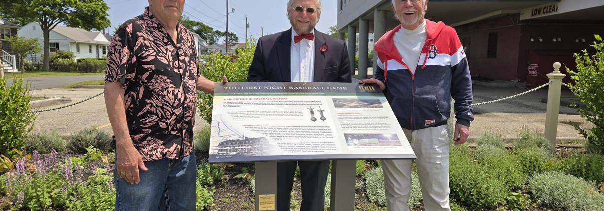 From left: Herb Crehan, Steve Greenberg, and Dennis Riley participate in a dedication ceremony on June 11, 2025, at a newly installed storyboard exhibit for the first night baseball game played in Hull, Massachusetts.