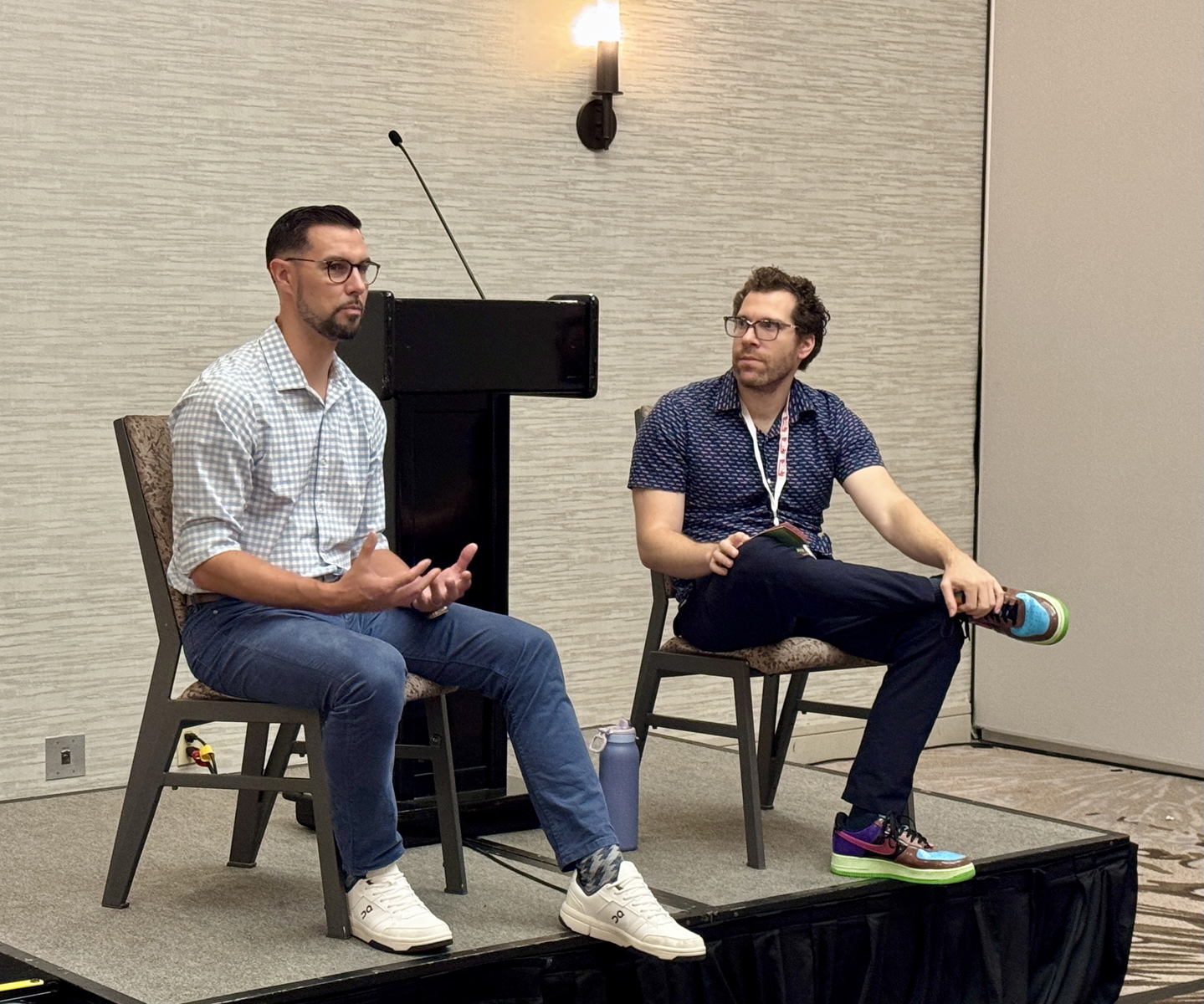 Tony Barnette, left, and Aaron Fischman speak during the Asian Baseball Committee meeting at SABR 53 on June 28, 2025, in Irving, Texas.